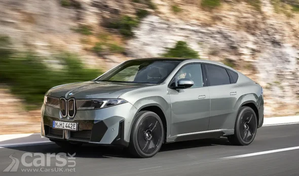 BMW iX4 front view on a road showing its sleek design