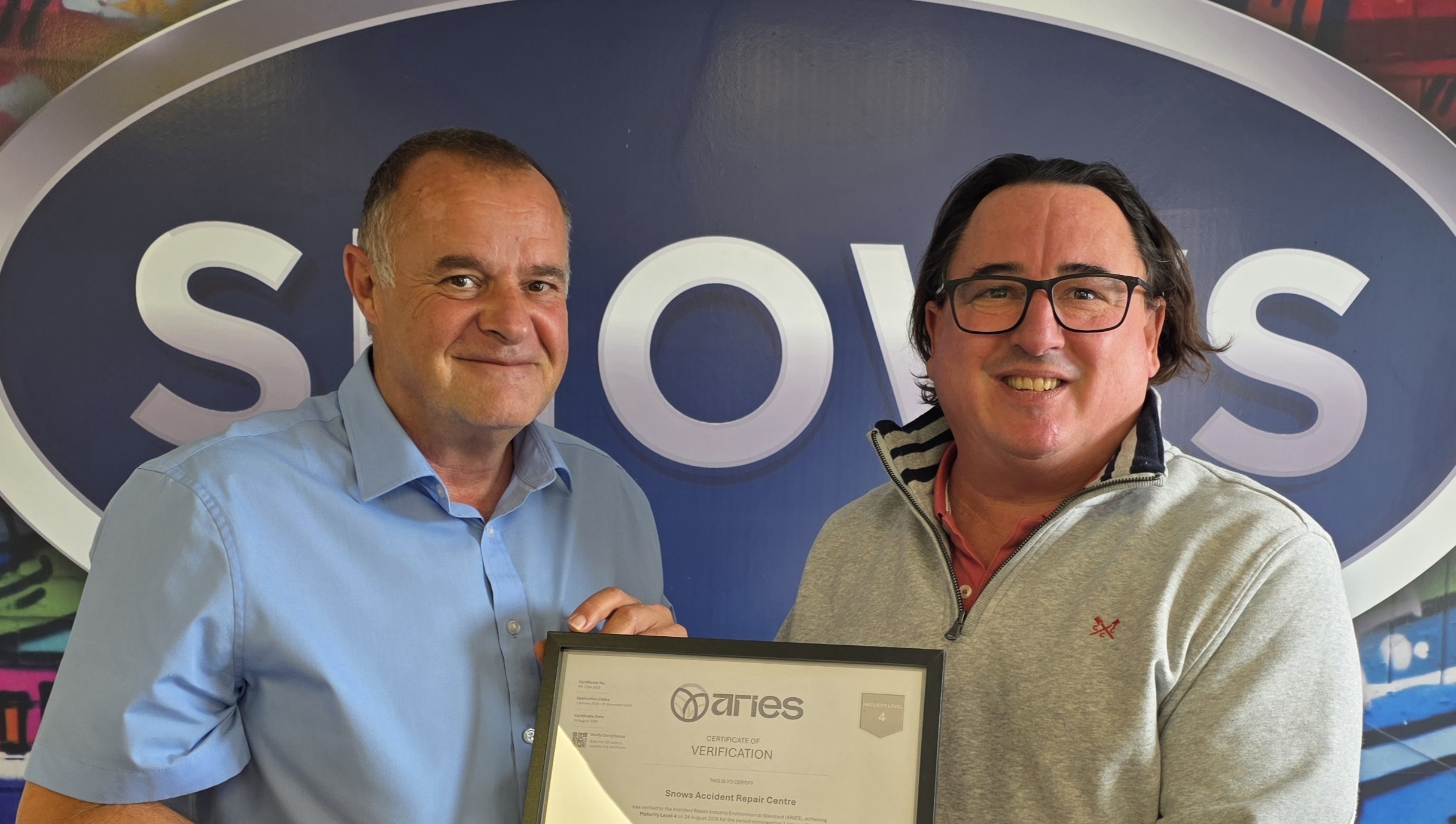 Dan Bush and Roy Edwards holding the Level 4 ARIES certificate at Snows Accident Repair Centre