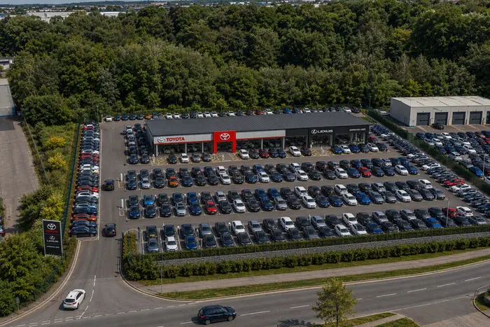 Construction site of the new Toyota and Lexus dealership in Poole, shown with scaffolding and signage