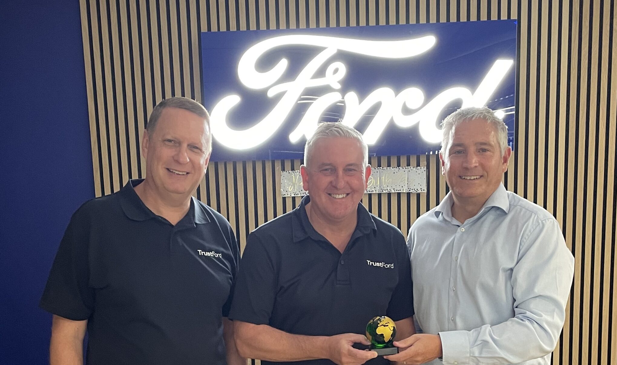 Why has TrustFord won an international green award for cutting dealership emissions?