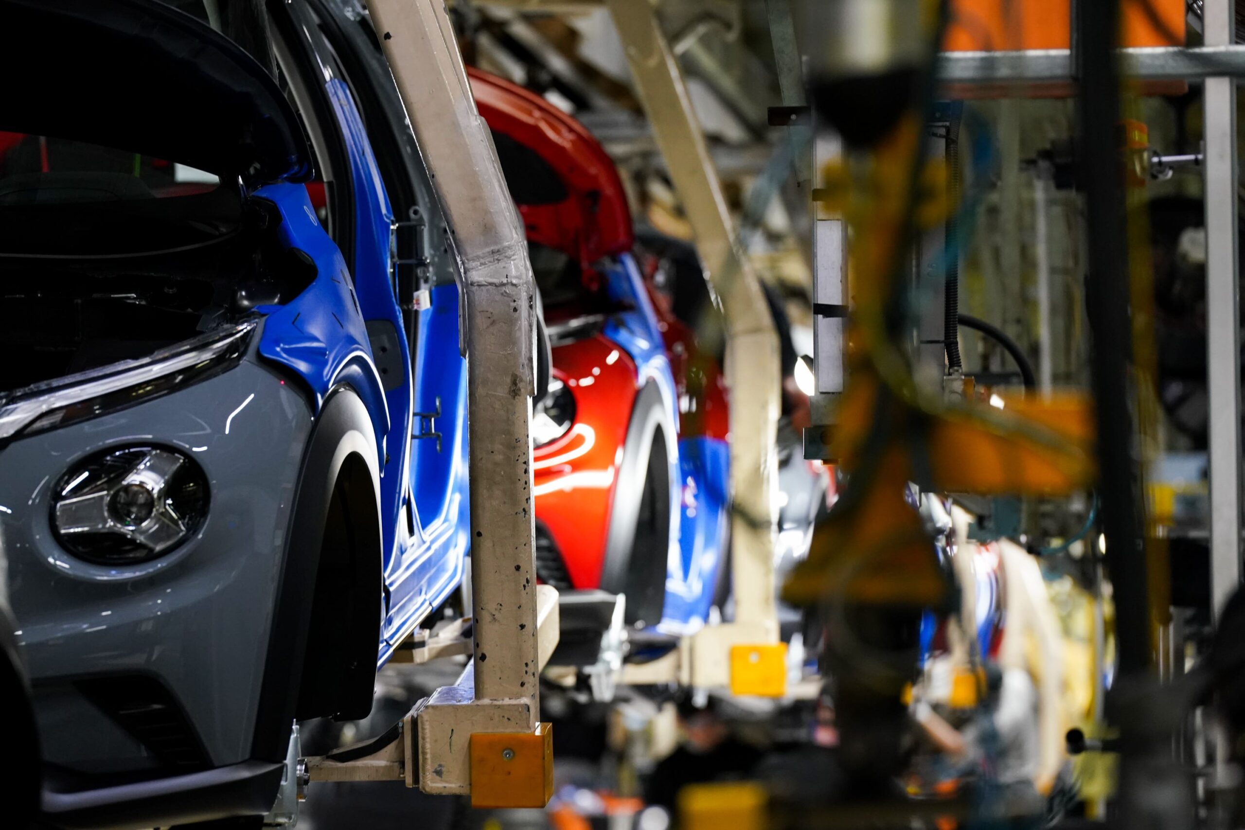 British car assembly line with vehicles on moving conveyors