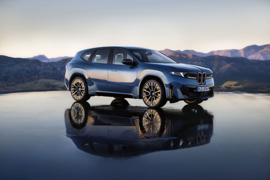 BMW electric vehicle on showroom floor with branding highlighting two‑millionth delivery milestone