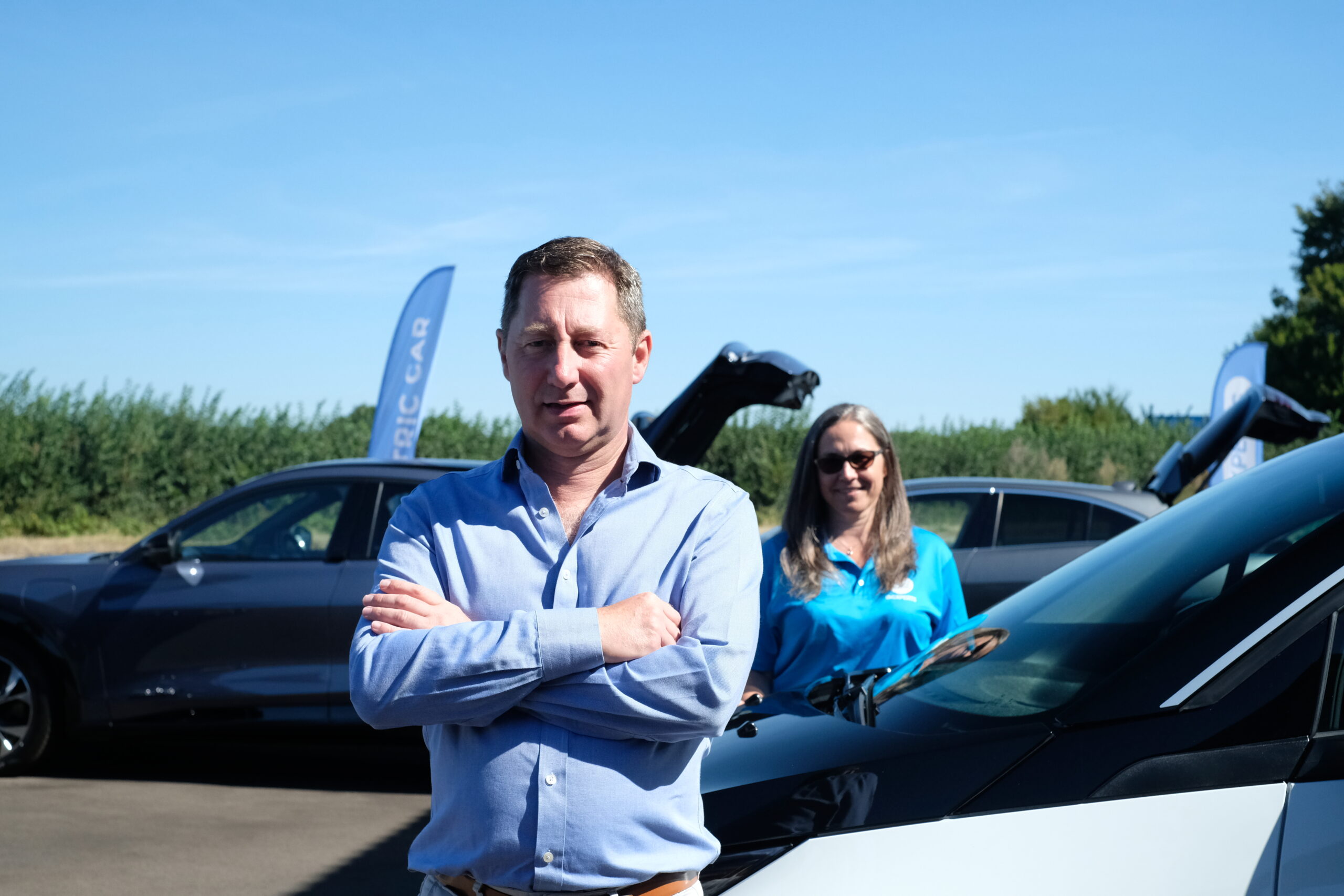 family members standing in front of a car dealership